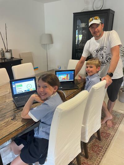 Ian Faulkner watches daughter Lily, 11, and son Jack, eight, learn money management skills on the Squirrel Education platform. Photo: Ian Faulkner