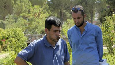 Readers express sympathy for Abdullah Kurdi, the father of Aylan Kurdi, left, following the publication of a cartoon on the dead toddler by the French magazine Charlie Hebdo. Tolga Adanali / Depo Photos via AP Photo