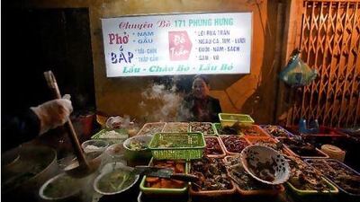A street food vendor sells pho bo (an aromatic noodle soup) and various other dishes in Hanoi, Vietnam. The city offers a bewildering array of street food, from pancakes to sticky rice. Most offerings cost less than a few US dollars, and at Hang Dieu Street in the city's old quarter, travellers may sample local delicacies such as mien luon (noodles with eels, with ginger and lemon) or che, a rice pudding that is served cold. Justin Mott / Bloomberg