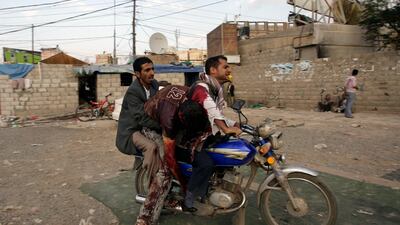 Anti-government protesters use a motorcycle to evacuate Hassan Wadaf, a cameraman wounded at the site of clashes with security forces, in Sanaa, Yemen, on September 19 2011. Hani Mohammed / AP Photo