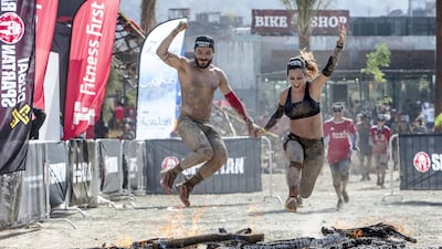 Participants finish the race by jumping over fire.