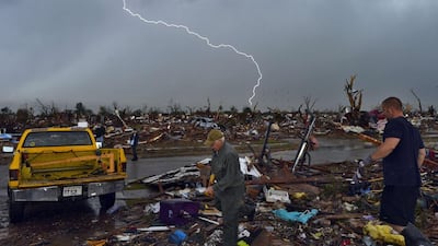 Lightning strikes during a thunder storm as tornado survivors search for salvagable stuffs at their devastated home in 2013. Jewel Samad/AFP