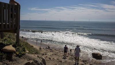 Tourists look out to sea and the GE-Alstom Block Island wind farm. Scott Eisen / Getty / AFP