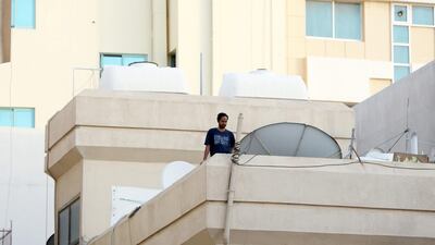 A resident looking at the streets from his home in Al Ras area in Deira Dubai. Pawan Singh / The National