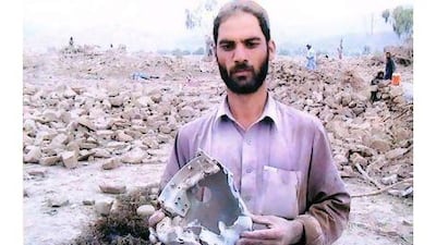 A man holds debris from a missile strike in North Waziristan, one of a series of pictures a gallery in London is staging allegedly showing innocent civilians killed by US drone missile strikes in Pakistan's tribal region along the Afghan border. Noor Behram / AP Photo