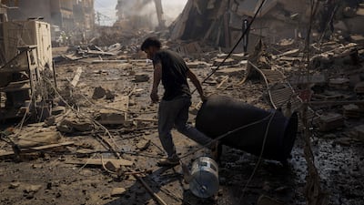 A man walks through debris at the site of an Israeli strike on Tyre, southern Lebanon. Reuters