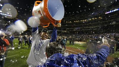 Kansas City Royals catcher Salvador Perez dumps water on manager Ned Yost after Game 5 of the Major League Baseball World Series against the New York Mets Monday, Nov. 2, 2015, in New York. The Royals won 7-2 to win the series. (AP Photo/Matt Slocum)