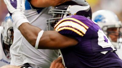 Detroit Lions quarterback Matthew Stafford, left, grimaces as he is hit by Minnesota Vikings defensive tackle Kevin Williams during the fourth quarter of their NFC football game in Minneapolis September 25, 2011. Detroit won the game in overtime. Eric Mil???