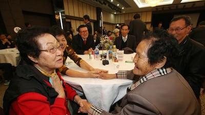 North Korean Rim Ok-Rye, right, talks with her South Korean sister Lim Ok-Nam, left. AFP