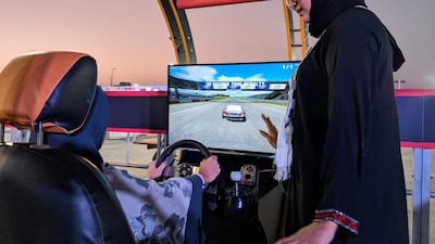 Amina Abu Al Ola guides Rohood Bugis as she takes the wheel in a virtual training area set up in Jeddah on June 23, 2018 as the clicked down to the midnight lifting of a ban on Saudi women driving on public roads. Naser Al Wasmi / The National