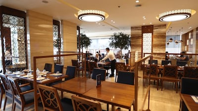 Staff serve diners at a restaurant in Dubai. Food outlets in the emirate are not required to serve food out of public view during fasting hours this year. EPA