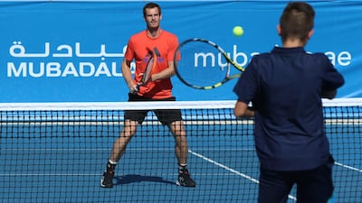 Andy Murray plays with a kid at the Mubadala Community Cup clinic in 2013. Delores Johnson / The National