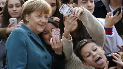 Pupils take mobile phone ‘selfies’ with German Chancellor Angela Merkel, as she arrives for a visit at Robert-Jungk Europe high school as part of the Europe-Project Day, in Berlin. Fabrizio Bensch /Reuters