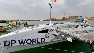 A man checks the last details on the Row4ocean rowing trimaran. AFP