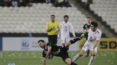 Xavi of Al Sadd goes down against Al Jazira’s Park Jong-woo on Tuesday night. Jeffrey E Biteng / The National