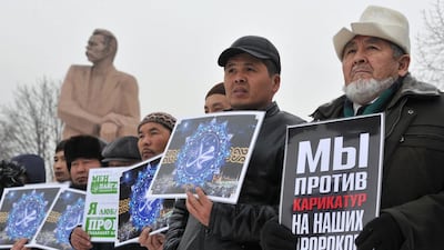 People hold banners reading “I love Mohammed, we are against the cartoons of our Prophets” as they take part in a rally against the publication of cartoons of the Prophet Mohammed by French satirical weekly newspaper Charlie Hebdo in front of a Gorky monument in Kyrgyzstan’s capital Bishkek on January 20, 2015. Protests have erupted in several Muslim countries since Charlie Hebdo published Mohammed cartoons in its “survivors’ issue” on January 14, a week after 12 people were killed in an attack by Islamist gunmen on its Paris offices. Vyacheslav Oseledko / AFP photo