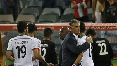 Iran coach Carlos Queiroz, centre, consoles players after their Asian Cup quarter-finals defeat to Iraq on Friday. Edgar Su / Reuters / January 23, 2015