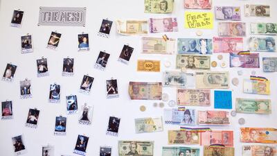 World currencies and photographs are displayed on a wall at the ConsenSys Inc. office in the Brooklyn borough of New York, U.S., on Thursday, March 29, 2018. The employees of ConsenSys, the blockchain startup co-created by Ethereum guru Joseph Lubin, have taken over the space at 49 Bogart Street in the Bushwick neighborhood of Brooklyn. Photographer: Holly Pickett/Bloomberg