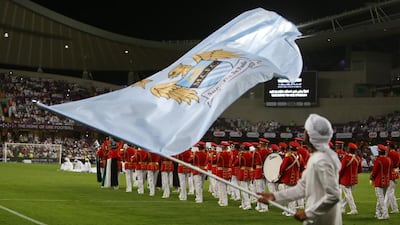 An Emirati man waves the flag for the newly crowned Premier League champions Manchester City, as preliminary celebrations get under way before City’s much-awaited friendly against Al Ain to launch the Garden City club’s Hazza bin Zayed Stadium. Marwan Naamani / AFP