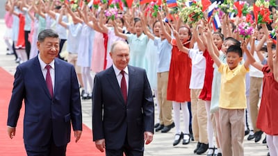 Russian President Vladimir Putin, right, is welcomed by Chinese President Xi Jinping at a ceremony at the Great Hall of the People in Beijing. EPA
