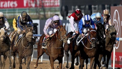 Jockey Paul Hanagan riding Tamarkuz (third from right) wins the Godolphin Mile during the Dubai World Cup at the Meydan Racecourse in Dubai. ( Satish Kumar / The National )