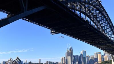 Greenpeace activists can be seen suspended from the under-carriage of the Sydney Harbour Bridge in Sydney, Australia, May 14, 2019. AAP via REUTERS