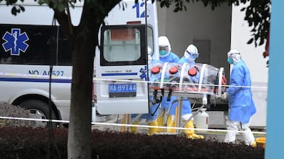 Medical workers in protective suits lift an isolated patient from an ambulance as the country is hit by an outbreak of the new coronavirus, in Chengdu, Sichuan province, China. Reuters