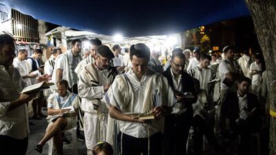 Relatives and friends of Israelis taken hostage during the attack on Israel by Hamas militants on October 7, 2023, block a road in Jerusalem to pray for their release at the start of the Jewish holiday of Yom Kippur. AFP