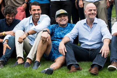 Italian goalkeeper Gianluigi Buffon, left, former Argentinian soccer star Diego Maradona, center, and FIFA President Gianni Infantino, right, pose for a photo before the Gianni's game, a soccer match with football legends, in Brig, Switzerland, Friday, July 7, 2017. (Jean-Christophe Bott/Keystone via AP)