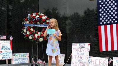 Eliana Duy, 8, FL, stands in front of the wreath that US Secretary of Defense James Mattis, General John Kelly, White House Chief of Staff and Cindy McCain, wife of late Senator John McCain, lay a ceremonial wreath honouring all whose lives were lost during the Vietnam War. Reuters