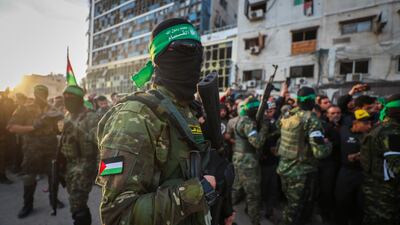 Fighters from the Ezzedine Al Qassam Brigades, the military wing of Hamas, arrive to collect Israeli hostages under the ceasefire agreement with Israel, in Gaza City. AP