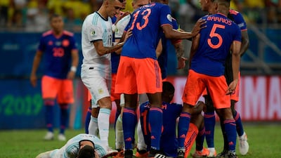 Argentina's Lionel Messi lies on the ground after being fouled by Colombia's Juan Cuadrado. AFP