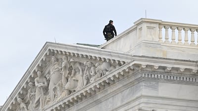 A Capitol Police officer stands on the roof. Reuters