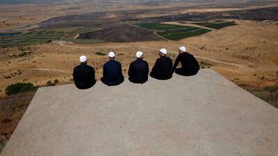 Druze men look out across Quneitra in south-west Syria, at the Israeli-annexed Golan Heights on the frontier. AFP