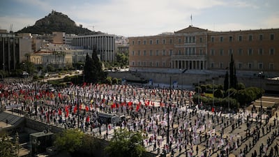 Members of the communist-affiliated trade union PAME practice social distancing during a rally commemorating May Day in Athens, Greece. Reuters