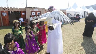 School children pet a falcon.