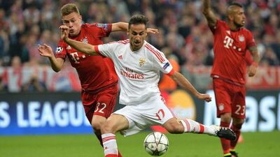 Benfica's Jonas, centre, vies for the ball with Bayern's Joshua Kimmich, left, during the Champions League quarterfinal first leg soccer match between FC Bayern Munich and Benfica Lisbon at the Allianz Arena in Munich, southern Germany, Tuesday, April 5, 2016. (AP Photo/Kerstin Joensson)