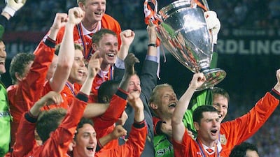 Manchester United's players celebrate with the trophy. AFP
