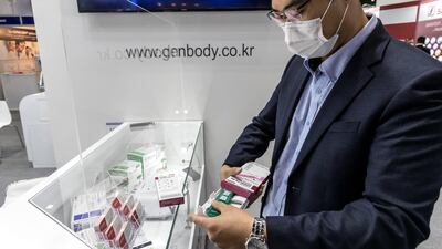Steve Lee, Regional Sales Manager of Gen Body Inc from Korea holds one of their Covid-19 home test kits. Antonie Robertson / The National