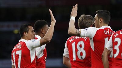 Arsenal’s Alexis Sanchez celebrates scoring their first goal with teammates. Paul Childs / Reuters