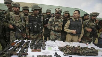 Indian soldiers display arms and ammunition recovered with the bodies of suspected militants in India-controlled Kashmir on October 6, 2016. Mukhtar Khan/AP Photo
