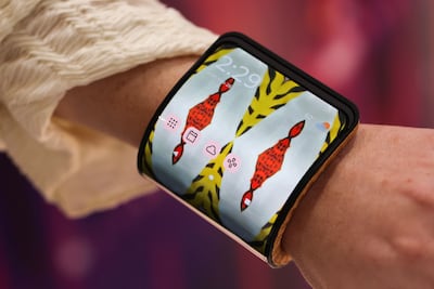 A visitor wears an adaptive smartphone display concept on their wrist at the Motorola Solutions booth on the opening day of the Mobile World Congress. Bloomberg