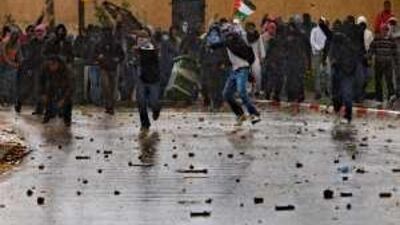 Israeli Arab youths throw stones at police during a march by Israeli right-wing extremists in the West Bank yesterday.