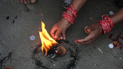 Indian devotees perform rituals. EPA