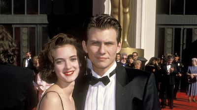 Winona Ryder, accompanied by Christian Slater, wears a classic strappy black dress at the Shrine Auditorium for the 61st Annual Academy Awards in Los Angeles, California on March 29, 1989. Getty