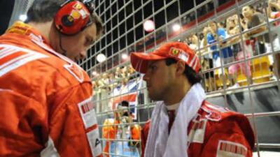Felipe Massa of Ferrari, right, looks dejected after retiring from the Singapore Grand Prix.