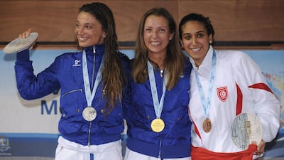 Bronze medalist Ines Boubakri, right, with silver medalist Margherita Granbassi and gold medalist Valentina Vezzali - both of Italy - on the podium at the XVI Mediterranean Games in Pescara, Italy, in 2009. Getty Images
