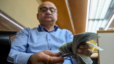 A trader counts US dollars at a currency exchange shop in Beirut. The Lebanese pound has tanked against the US dollar, rendering its peg to the greenback obsolete. EPA
