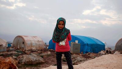 Syrian Maya Merhi stands outside a camp in Serjilla in northwestern Syria near the Turkish border, on December 9, 2018. AFP