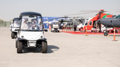 Sheikh Mohamed and Faisal Al Bannai, chief executive and managing director of Edge, right, in vehicle, tour the airshow.